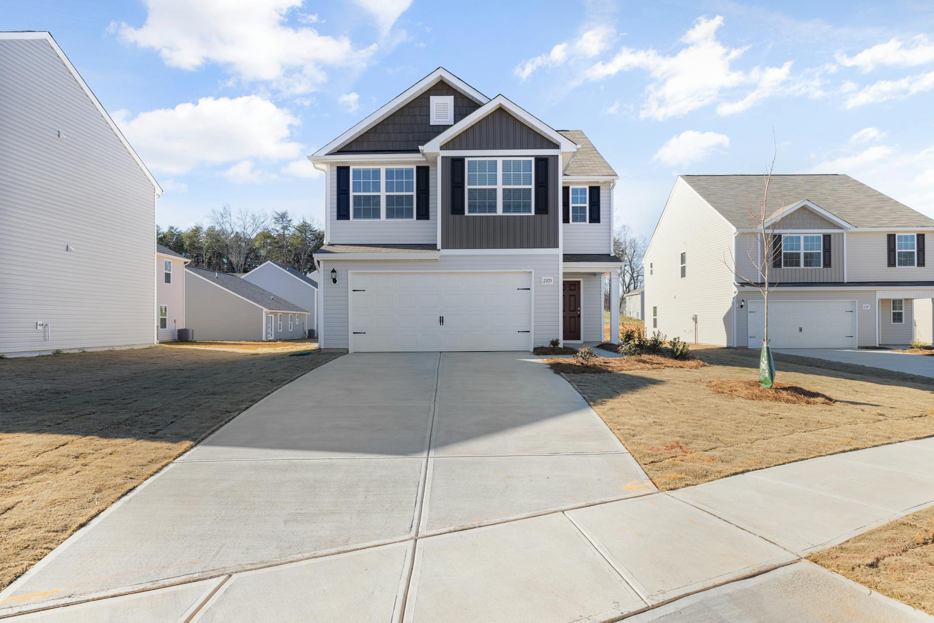 Two-story suburban home with a finished asphalt shingle roof